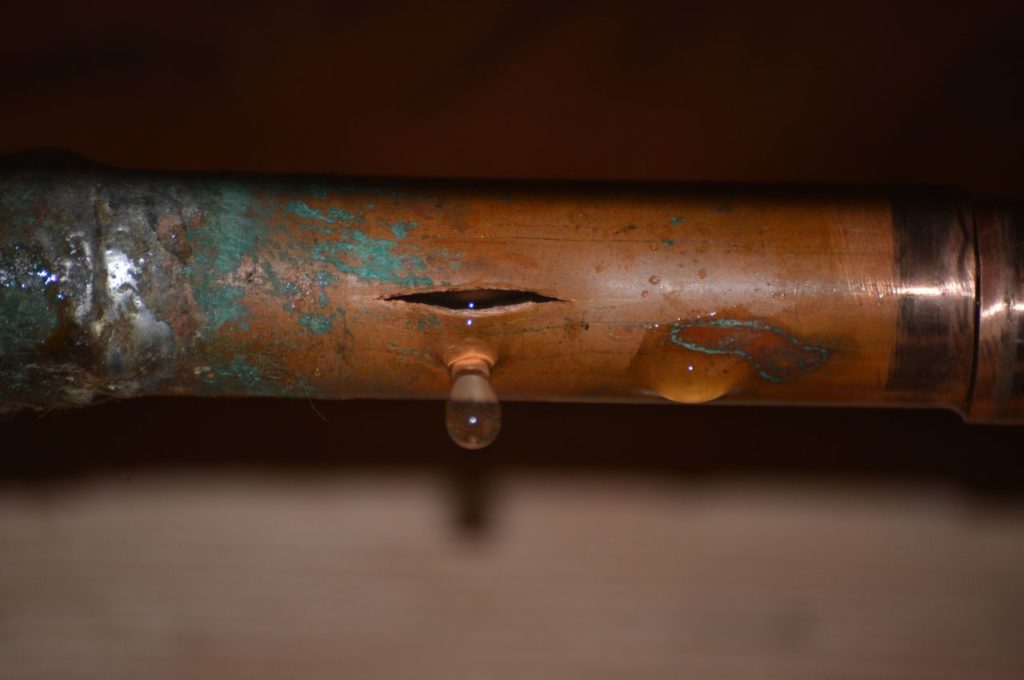 A burst copper pipe from assumedly winter weather.